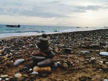 Rocks on beach against sky