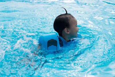 Boy swimming in pool