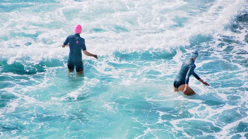 High angle view of swimmers enjoying in sea