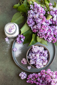 Flavored sugar with lilac flowers in glass jar and branch of lilac. edible flowers. 