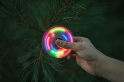 Close-up of man holding fidget spinner