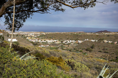 Scenic view of sea and townscape against sky