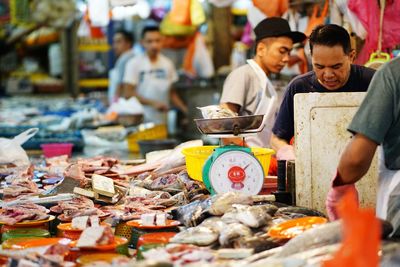 Group of people at market stall