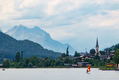 Scenic view of buildings and mountains against sky