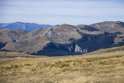 Scenic view of landscape and mountains against sky