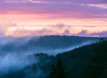 Scenic view of mountains against cloudy sky