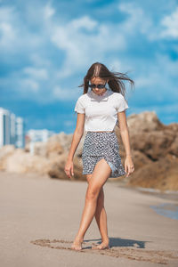 Full length of woman standing at beach