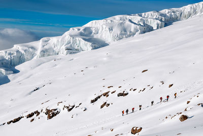 Scenic view of snow covered mountains against sky