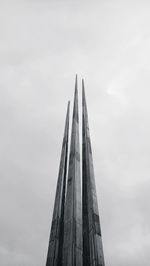 Low angle view of modern building against cloudy sky