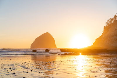 Scenic view of sea against clear sky during sunset