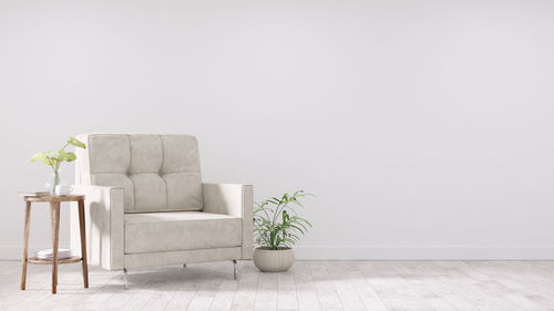 Potted plant on table against wall at home