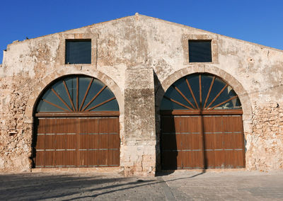 Entrance of old building against clear sky