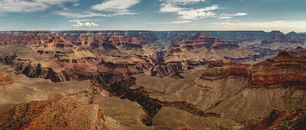 Panoramic view of rock formations against cloudy sky