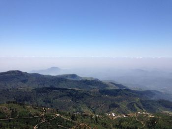 Scenic view of green mountains against sky