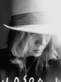 Close-up portrait of young woman wearing hat
