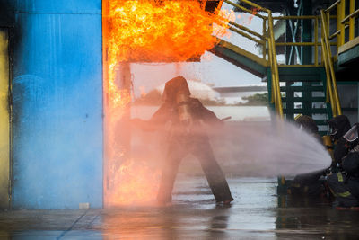 Firefighters spraying water on fire