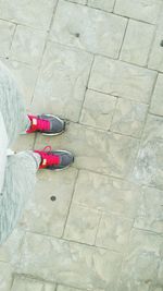 Low section of woman standing on tiled floor