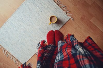 Low section of woman on hardwood floor at home