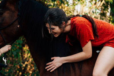 Portrait of woman sitting on horse