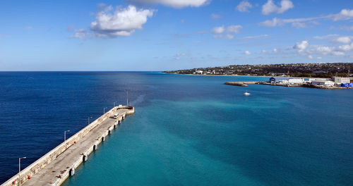 Scenic view of swimming pool by sea against sky