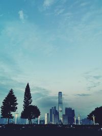 Silhouette trees and buildings against sky