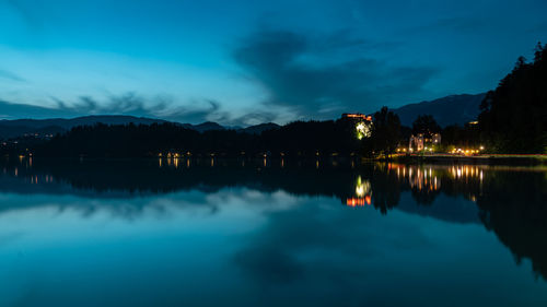 Scenic view of lake against sky at dusk