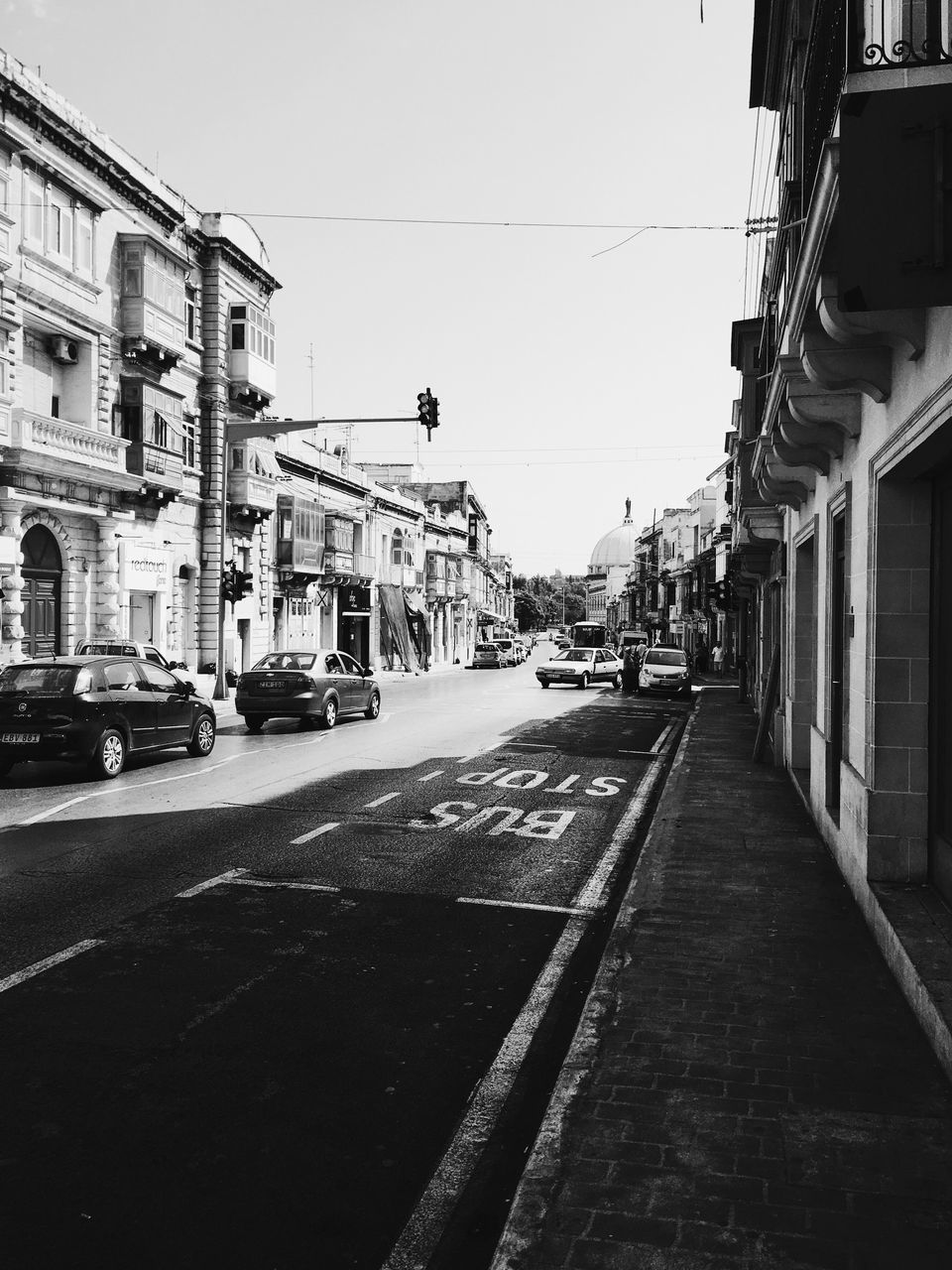 VIEW OF CITY STREET ALONG BUILDINGS