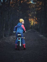 Girl on bike in dark evening park at spring