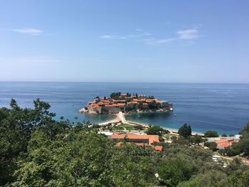 High angle view of sea and buildings against sky
