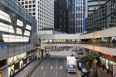 Traffic on road amidst buildings in city