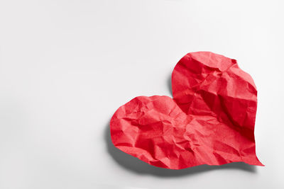 Close-up of red heart shape on white background