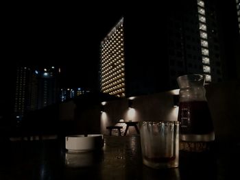 Close-up of wine glass on table in illuminated building