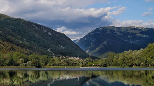 Scenic view of lake and mountains against sky