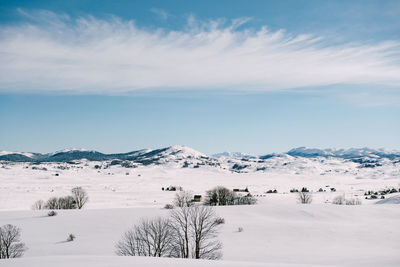 Scenic view of snow covered mountains against sky