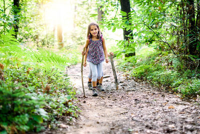 Portrait of girl walking in forest