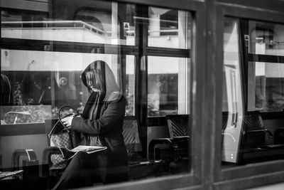 Reflection of people on window at home