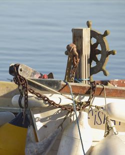 Close-up of rope tied to bollard against sea