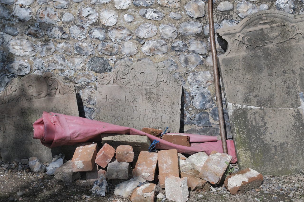 SIDE VIEW OF WOMAN LYING ON WALL