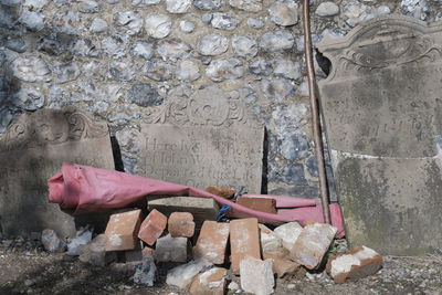 Side view of man lying on rock against wall