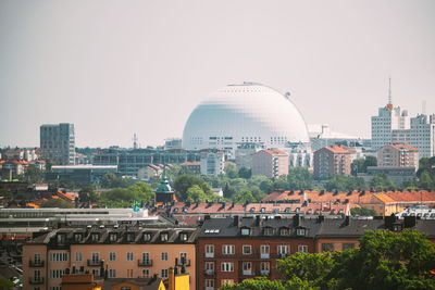 Buildings in city against clear sky