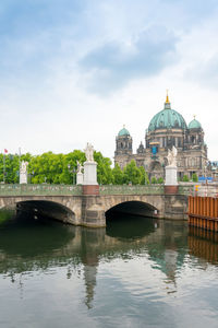 Arch bridge over canal against berlin cathedral