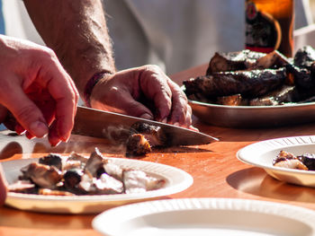 Midsection of person preparing food on table