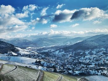 Aerial view of snowcapped mountains against sky