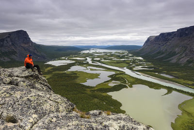 Hiker looking at view from cliff