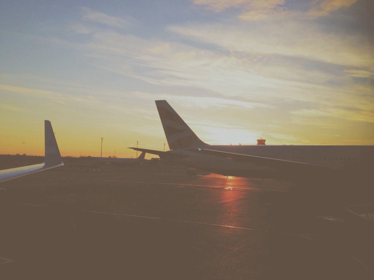 AIRPLANE FLYING OVER RUNWAY AGAINST SKY