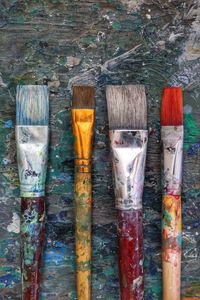 Close-up of paintbrushes arranged on table