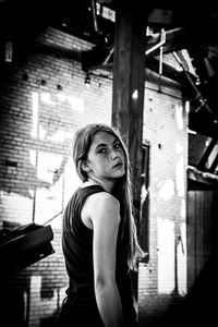 Portrait of girl standing in decrepit building