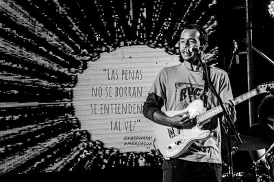 Portrait of smiling man standing at music concert