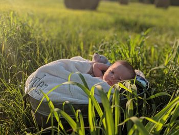 Portrait of cute baby boy in container on land