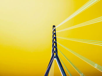 Low angle view of suspension bridge against sky